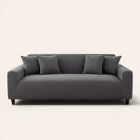 Charcoal gray corduroy stretch cover fitted on a three-seat sofa, front view on ivory backdrop