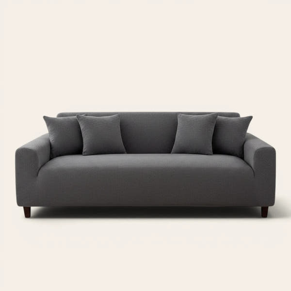 Charcoal gray corduroy stretch cover fitted on a three-seat sofa, front view on ivory backdrop