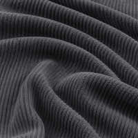 Macro of charcoal gray corduroy fabric in soft folds revealing the ribbed knit texture
