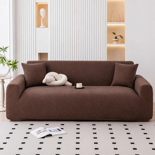 Cocoa brown corduroy sofa cover in a modern living room with fluted wall and cream cushions