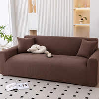 Cocoa brown corduroy sofa cover styled with cushions and a knot pillow in a bright room