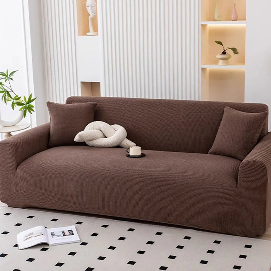 Cocoa brown corduroy sofa cover styled with cushions and a knot pillow in a bright room