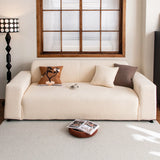 Cream corduroy sofa cover styled in a bright living room with terracotta and brown cushions