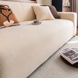 Angled close-up of the cream corduroy cover seat and armrest showing the ribbed texture