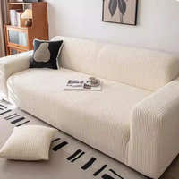 Close up of wide wale cream whisper corduroy sofa cover with a book and coffee cup