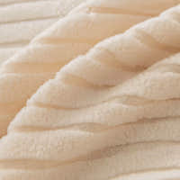 Macro of plush cream whisper corduroy fabric with its soft raised ribbing