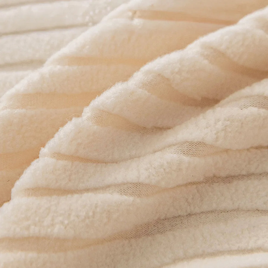 Macro of plush cream whisper corduroy fabric with its soft raised ribbing