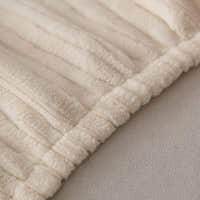 Detail of the gathered elastic hem on the cream whisper corduroy sofa cover
