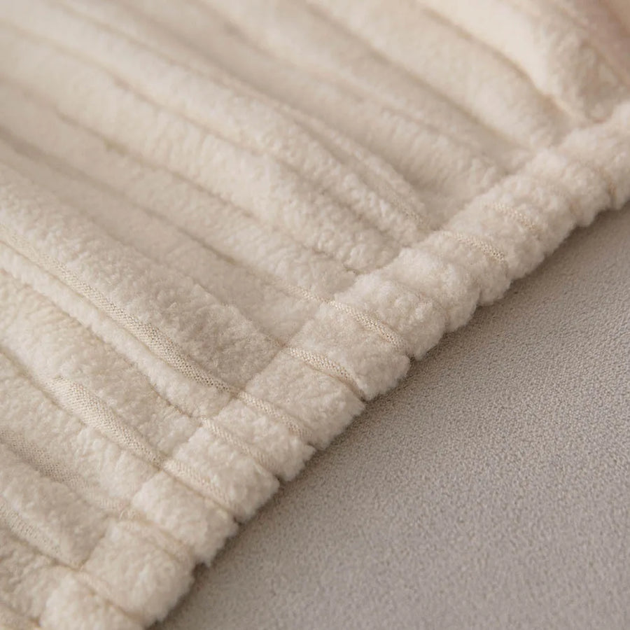 Detail of the gathered elastic hem on the cream whisper corduroy sofa cover
