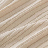 Close up of the fine ribbed texture on soft cream whisper corduroy fabric