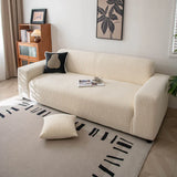 Cream whisper corduroy sofa cover styled in a sunlit room with a cushion and patterned rug