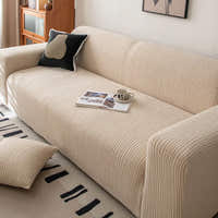 Close up of wide wale linen beige corduroy sofa cover with a book and coffee cup