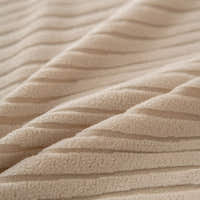 Macro of chunky linen beige corduroy fabric with its raised vertical ribbing