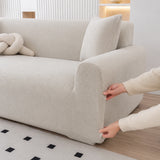Hands stretching the mist gray corduroy cover snugly around a sofa armrest