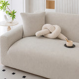 Close up of mist gray corduroy sofa cover corner with a square cushion and coffee cup