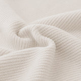 Macro of soft mist gray corduroy fabric with its fine vertical ribbing swirled