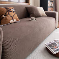 Close up of ribbed mocha brown corduroy sofa cover with cushions and a coffee cup