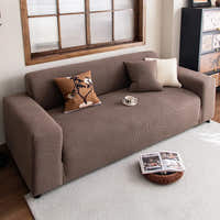 Mocha brown corduroy sofa cover styled in a warm living room with layered cushions