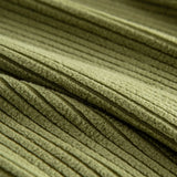 Macro of olive green corduroy fabric revealing its plush vertical ribbed weave