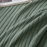 Macro of soft olive mist corduroy fabric showing its raised vertical ribbing