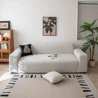 Silver Cloud corduroy sofa cover in a bright living room with botanical art and a palm plant