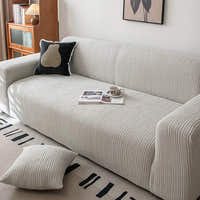 Silver Cloud corduroy sofa cover styled with a black accent cushion and an open magazine