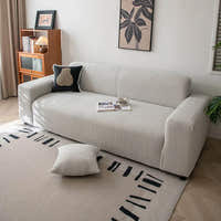 Silver Cloud corduroy sofa cover in a minimalist living room set on a graphic patterned rug