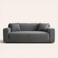 Steel Gray corduroy sofa cover fitted on a three-seat sofa with matching cushions, front view on ivory