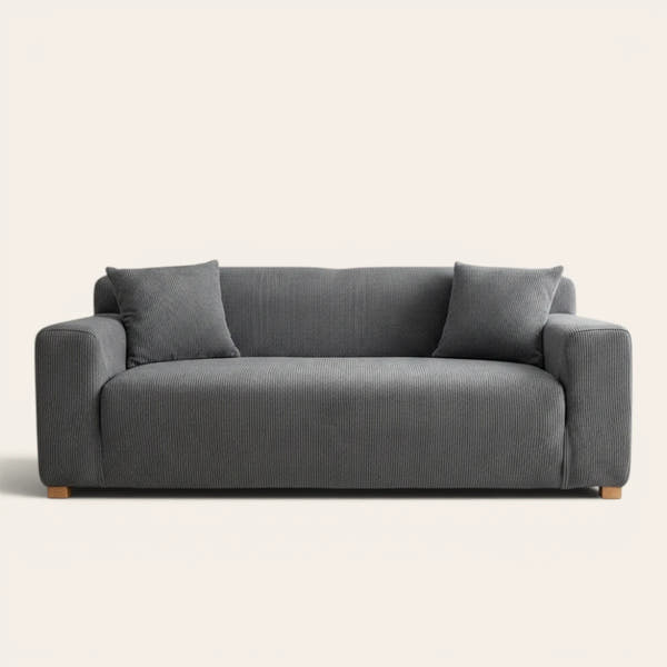 Steel Gray corduroy sofa cover fitted on a three-seat sofa with matching cushions, front view on ivory