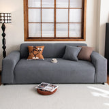 Steel Gray corduroy sofa cover in a living room with a wood-framed window and floor lamp