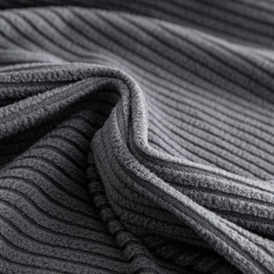 Macro close-up of the Steel Gray corduroy fabric showing its soft wide-wale ribbing