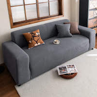 Steel Gray corduroy sofa cover in a cozy living room with botanical and brown accent cushions