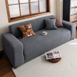 Steel Gray corduroy sofa cover in a cozy living room with botanical and brown accent cushions