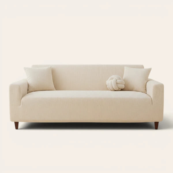 Warm beige corduroy sofa cover fitted on a three seater sofa, front view on ivory