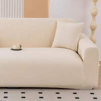 Warm beige corduroy stretch sofa cover in a bright room with a cushion and coffee cup