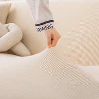 Hand stretching the warm beige corduroy cover to show its flexible ribbed fabric
