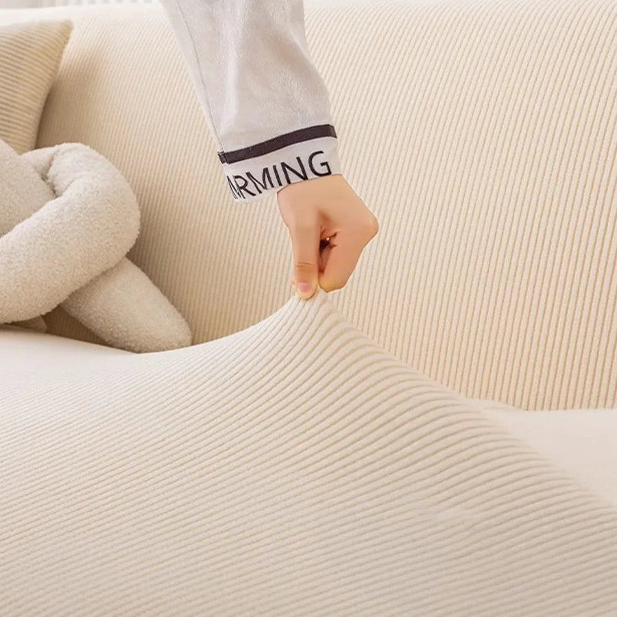 Hand stretching the warm beige corduroy cover to show its flexible ribbed fabric