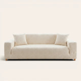 Cream Petal floral sofa cover fitted on a three-seat sofa with matching cushions, front view on ivory