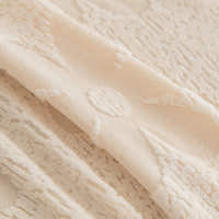 Macro close-up of the Cream Petal fabric showing its plush embossed floral relief