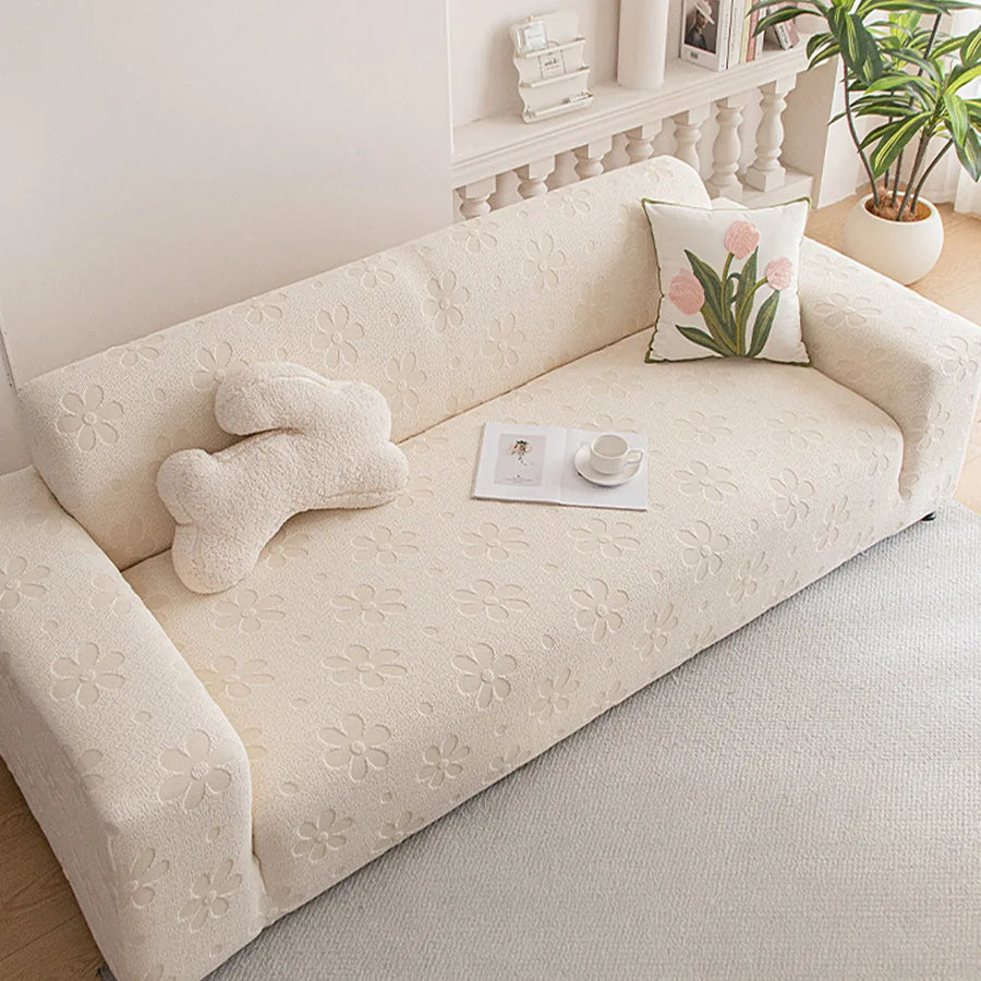 Cream Petal floral sofa cover styled in a bright living room with a tulip accent cushion