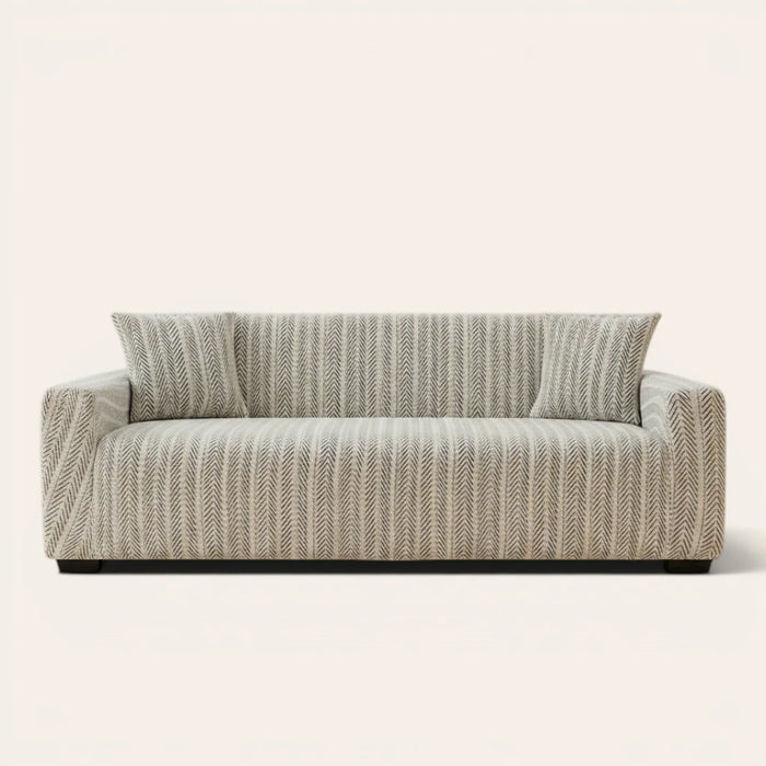 Arrow Gray geometric sofa cover fitted on a three-seat sofa with matching cushions, front view on ivory