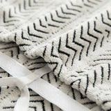 Macro close-up of the Arrow Gray woven fabric showing its chevron geometric pattern and elastic strap
