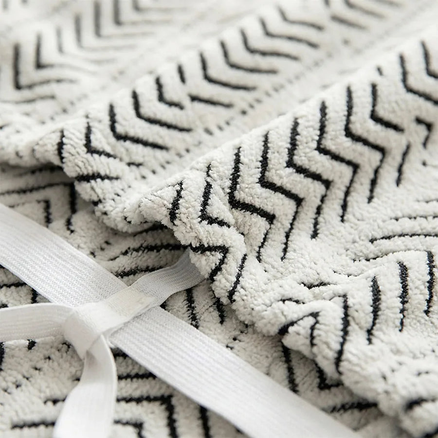 Macro close-up of the Arrow Gray woven fabric showing its chevron geometric pattern and elastic strap