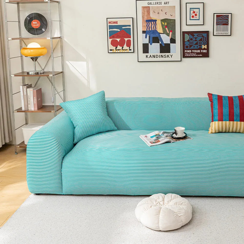 Aqua Mist ice silk sofa cover in a bright living room with a gallery wall and coffee cup