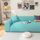 Aqua Mist ice silk sofa cover in a bright living room with a gallery wall and coffee cup