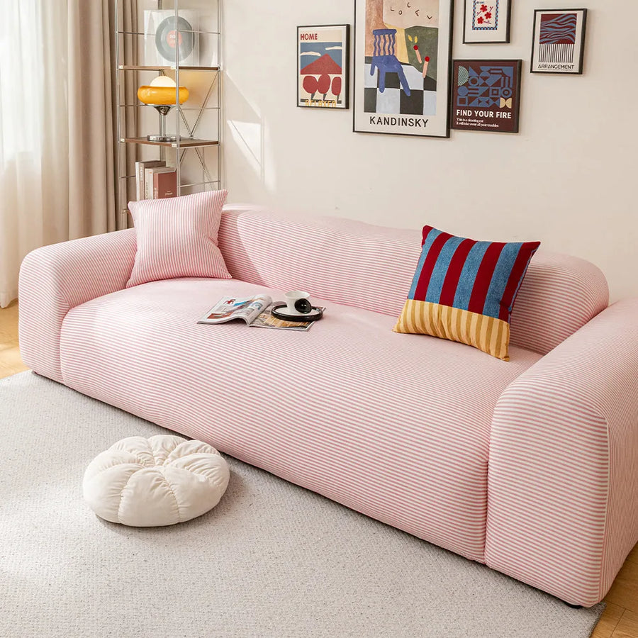 Blush Petal ice silk sofa cover styled in a living room with a striped accent cushion