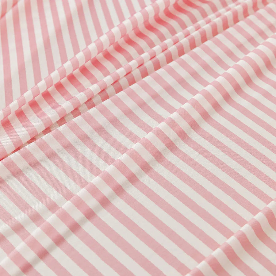 Macro close-up of the Blush Petal ice silk fabric showing its soft pink and white stripe