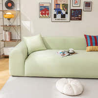 Mint Breeze ice silk sofa cover in a bright living room, styled with books and a coffee cup