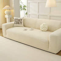 Angled view of the cream beige jacquard sofa cover, wavy texture styled with a teacup and cushions