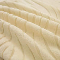 Macro of the cream beige jacquard weave, showing its soft raised wavy stripes